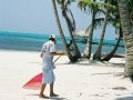 Man Sweeping the Beach