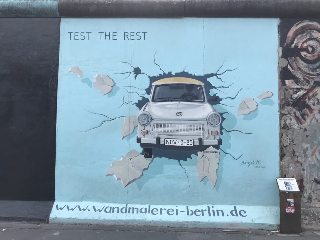 Berlin Wall East Side Art Gallery showing a car driving through the wall