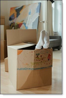 Moving Day - Humorous Packing Box with Feet Hanging Out