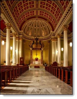 The inside of a beautiful Catholic church. Photo by Pixabay: https://www.pexels.com/photo/empty-cathedral-seats-and-hallway-with-lights-turned-on-208277/