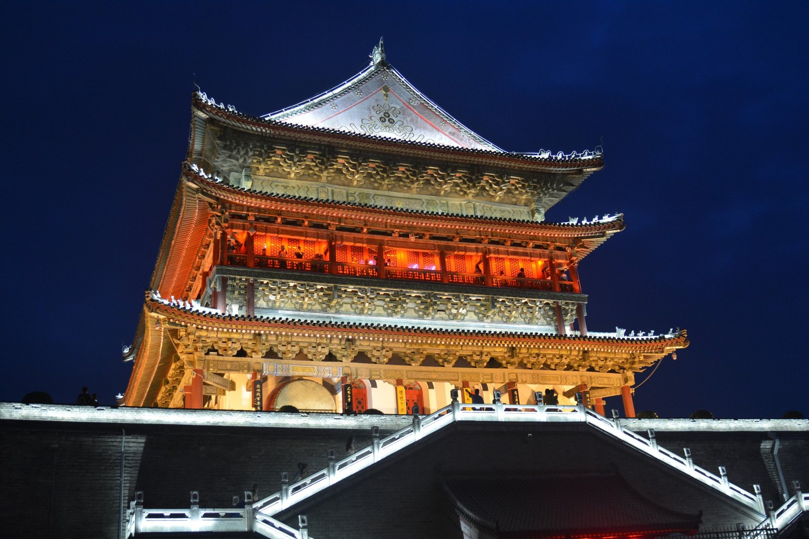 A traditional Chinese drum tower illuminated from the inside