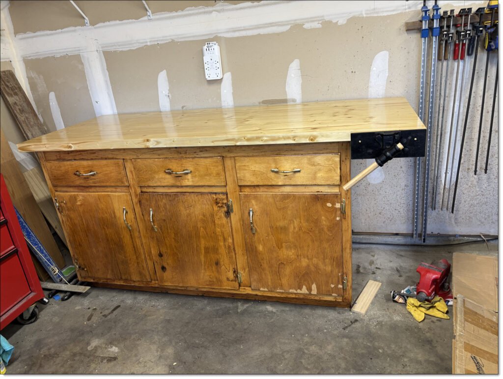 My newly built workbench, using a vintage kitchen cabinet base and new butcher block worktop. Vintage woodworking vise mounted on the right side of the top.