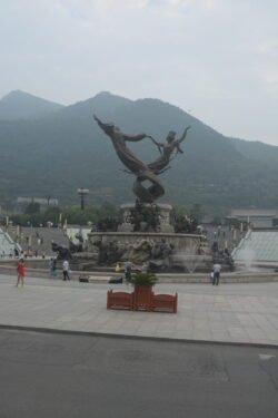 Bronze sculpture in front of the Huaqing Pool scenic area in Xi'an bronze sculpture in an open plaza, depicting the Chinese mythological figures Nüwa and Fuxi intertwined in a dance, symbolizing the creation myth.