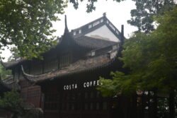 Coffee Comes to Hangzhou A chinese style building with a prominent Costa Coffee sign