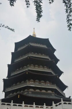 Leifeng Pagoda on West Lake in Hangzhou Looking up at a A Chinese pagoda topped with a golden spike,