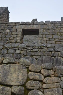 This is a combination of a stone retaining wall supporting a house in Machu Picchu.
