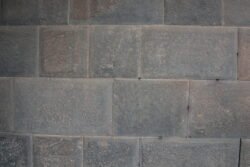 Detail of stonework of the ancient Temple of The Sun showing perfectly rectangular-cut blocks of gray stone. This is an example of cellular polygonal masonry.