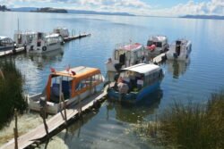 Early morning at the small harbor of Puerto Luis Banchero Rossi, Puno, on Lake Titicaca, Peru. These boats are used for general passenger and cargo transport around the lake, and out to the floating islands of Uros.