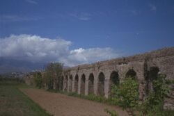 A Roman Aqueduct spanning an open fam field