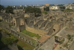 A view of walls of ancient buildings along a street.