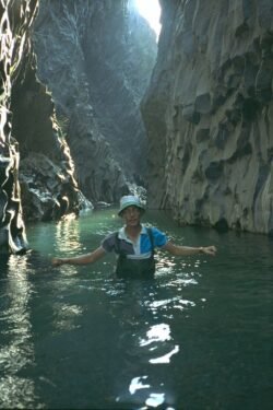 Ron standing in Waist Deep water in a rugged gorge