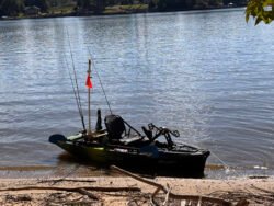 Native Watercraft Slayer Max 10 kayak, fully rigged for a day of fishing, sitting on a lakefront beach