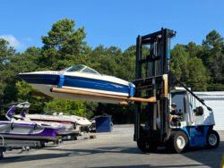 Bayliner 175BR "Sea Dragon" being moved from a Boatel to the water by a huge forklift.