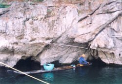 A Fishermen on the Lijiang River, China, using a traditional bamboo boat of large diameter bamboo tied together.