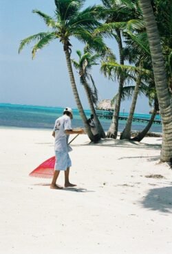 Man Sweeping the Beach