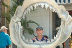 Ron with his head in the skeletal jaws of a giant shark.