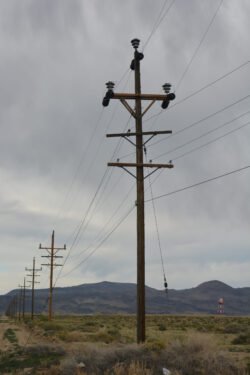 Telephone Poles in a row extending out into a desert along a road