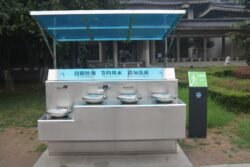 A Modern Drinking Fountain at Huaqing Palace a stainless steel outdoor drinking water fountain featuring multiple basins at different heights.