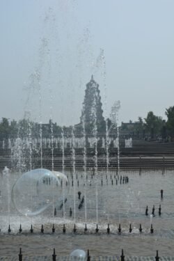 Looking Across a Plaza Water Fountain Towards Wild Goose Pagoda Looking Across a Plaza Water Fountain Towards Wild Goose Pagoda, Xi'an, China