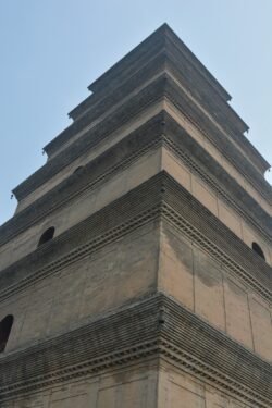 Giant Wild Goose Pagoda, also known as the Dayan Pagoda Looking up at a five-story chinese pagoda built of light brown brick.