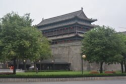 A View of Xi'an City Wall with Guard Post A large city wall with building topped with a traditional Chinese-style roof.