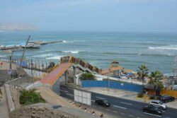 Looking Down on Playa Makaha Beach with a Large Pedestrian Walkway Crossing Over the main coastal highway of Cto. de Playas de la Costa Verde.
