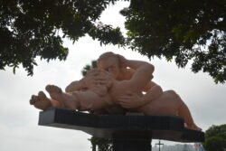 A large Statue in of two people making love on top of a pedestal