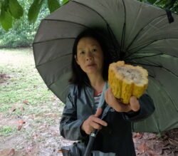 Winnie Shows off A Cacao Bean - Source of Chocolate