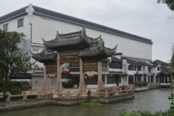 canal with a landing plaza covered with a highly ornate chinese-style roof supported by posts