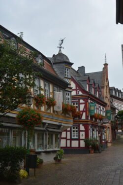 looking down a cobblestone street lined with german half-timbered buildings