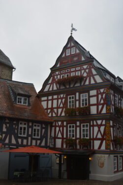 a large german half-timbered house on a street corner