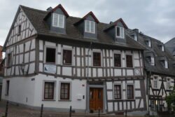 a half-timbered house of whitewashed stucco and dark wooden timbers
