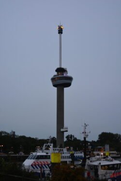 a needle tower with large structure midway up the tower
