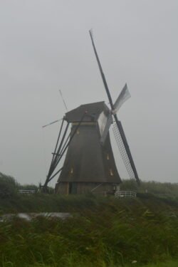 a windmill with sails facing into the wind.