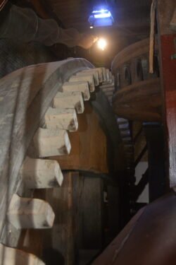 wooden toothed gear with a light above it