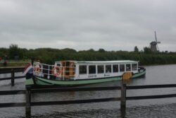 canal boat with windmill behind it